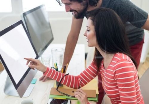 male-female-graphic-designers-interacting-computer (1)